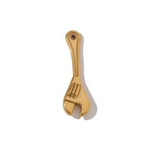 Close-up of a gold-plated stainless steel wrench pendant for personalized jewelry making
