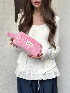 Detail of pink leopard plush makeup bag featuring soft faux fur and smooth zipper closure