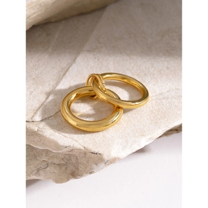 Polished 18k gold plated chunky stainless steel hoop earrings on a marble base