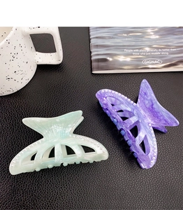 Detail of mint green and purple marble texture claw clips with pearl edge decoration