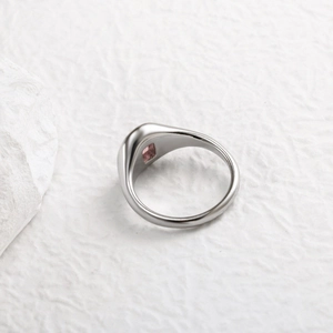Detailed close-up of a square pink zircon stone set on a silver stainless steel ring