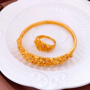 Detail of vintage gold flower jewelry set with matte finish and sparkling crystals