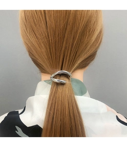 Silver metal hair clip hook on a blonde ponytail showcasing minimalist geometric design