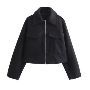 Detail view of the black woolen jacket featuring a lapel collar and large cargo pockets