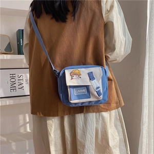 Detailed side view of Japanese style blue and white nylon crossbody bag for daily use