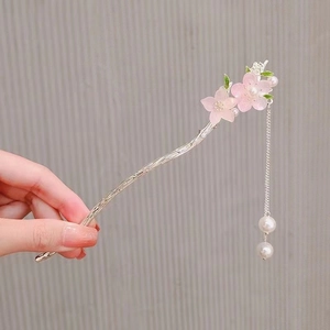 Detail of silver branch hair stick with pink flowers, pearls and long tassels