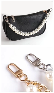 Close-up of elegant pearl and metal chain straps for handbags in gold and silver finish