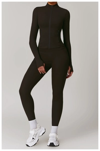 Detail of chocolate long sleeve workout jacket featuring thumb holes and zip-up collar