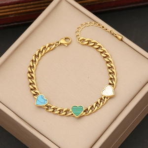 Gold butterfly heart bracelet with colorful enamel and pearl charms in jewelry box