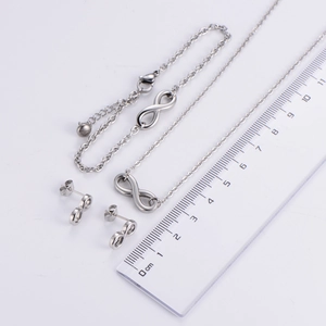 Titanium steel infinity jewelry set with necklace bracelet and earrings on ruler