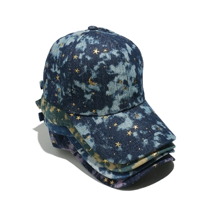 Gradient denim baseball caps with gold star and moon prints stacked in multiple colors