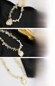 Detailed macro view of baroque pearls and citrine beads with 18K gold plated charms