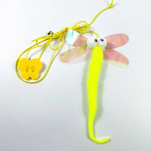 Detail of dragonfly cat toy with colorful wings, yellow plush body, and metallic bell