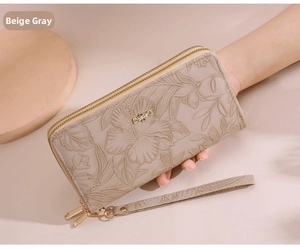 Detail of beige-grey long floral embossed wallet with dual zippers and wrist strap