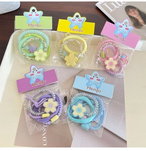 Detailed set of candy-colored elastic flower hair ties in five assorted vibrant colors