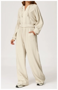 Detailed texture of women's beige cotton sportswear showing hood and ribbed cuffs
