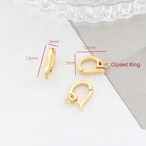 Macro shot of gold-plated jewelry clasps with cubic zirconia and closed jump rings
