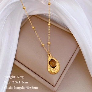 Detailed shot of gold titanium necklace with tiger eye pendant including 5.9g weight info