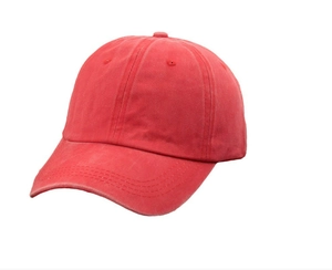 Close-up of washed red cotton baseball cap showing vintage twill texture and stitching