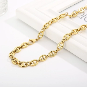 Macro detail of golden pig nose link chain with secure lobster clasp for necklace