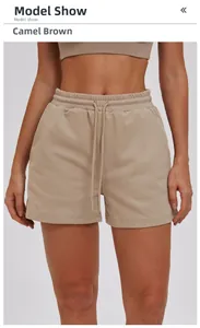 Detail of camel brown athletic shorts featuring elastic waistband and functional drawstrings