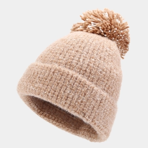 Detailed view of the thick knit texture and dual-tone pompom on the khaki winter beanie