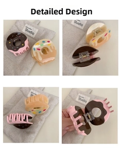 Detail view of donut-shaped acetate hair claw clips showing metallic spring and glossy finish