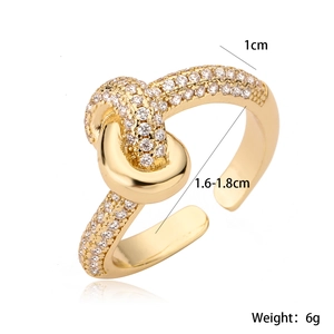 Detail of 18K gold plated knot ring with zircons showing 1cm width and 6g weight