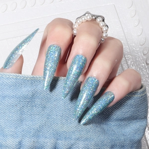Detailed view of long stiletto press-on nails with light blue laser glitter finish
