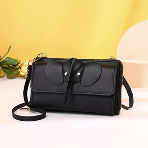 Macro detail of black elephant crossbody phone bag featuring lychee texture and 3D ear design
