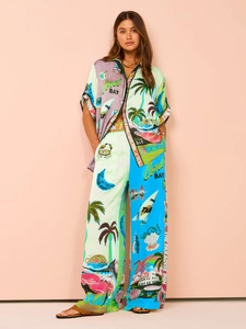 Detail of satin floral print resort set showing high waist wide leg trousers and shirt