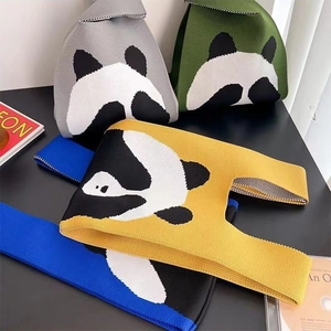 Detail of four colorful knitted panda handbags in gray, green, yellow, and blue colors