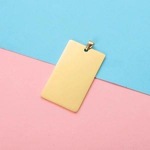 Close-up of golden rectangular stainless steel pet tag with polished mirror finish