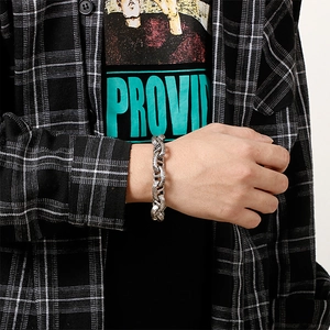 Close-up of vintage industrial steel bracelet with textured snake-scale link pattern