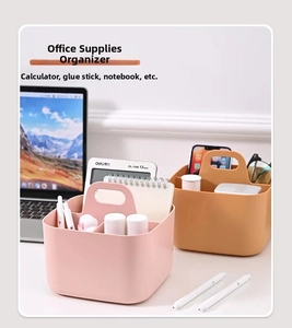 Detail of pink and orange plastic desktop storage basket with handle and two compartments
