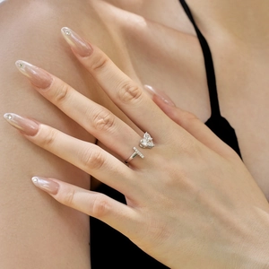 Detail of S925 silver ring featuring pear-shaped zircon and paved small diamonds on hand