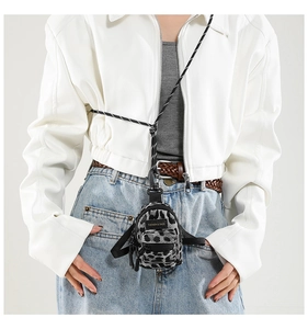 Detailed view of mini leopard print crossbody bag with rope strap and fashion label
