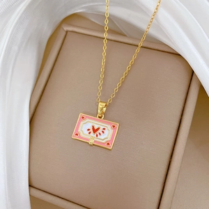 Elegant gold titanium steel necklace featuring a pink enamel heart frame pendant on silk