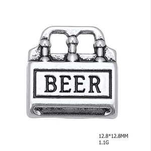 Detailed macro view of an antique silver beer crate charm for DIY jewelry making