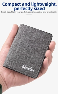 Slim canvas wallet in grey held by hand to show its compact and ultra-thin minimalist size