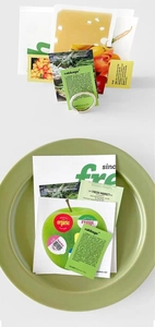 Detailed view of fruit and vegetable themed paper stickers in a ceramic plate