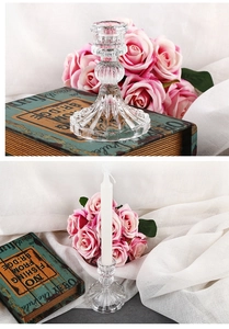 Close-up of a vintage glass candle holder base with elegant floral patterns on a soft fabric