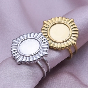 Detailed close-up of gold and silver sunburst rings on purple silk fabric background