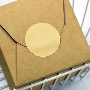 Brown kraft paper round adhesive labels on gift box for packaging and organizing