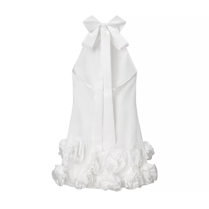 Elegant white backless halter dress featuring a large bow and 3D floral hem details