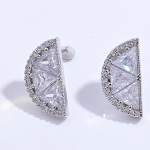 Detail of silver fan-shaped stud earrings with geometric clear cubic zirconia crystals