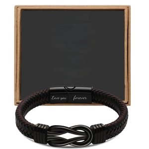 Detail of black leather bracelet with Love You Forever engraving on magnetic clasp