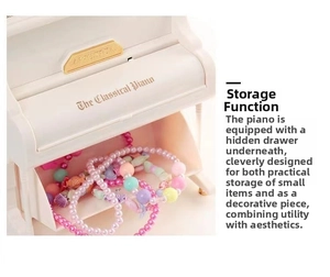 Detail view of white piano music box showing hidden drawer for jewelry storage