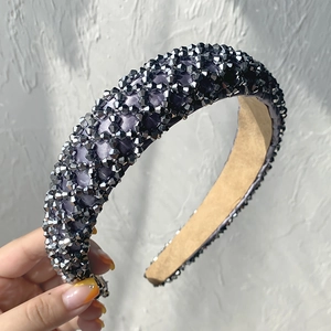 Detail of dark grey satin headband hand-held with sparkling faceted crystal beads