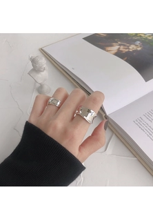 Detailed macro view of S925 sterling silver rings with engraved fashion slogan on the band